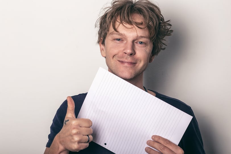 Smiling man making a positive gesture to symbolize motivation and confidence