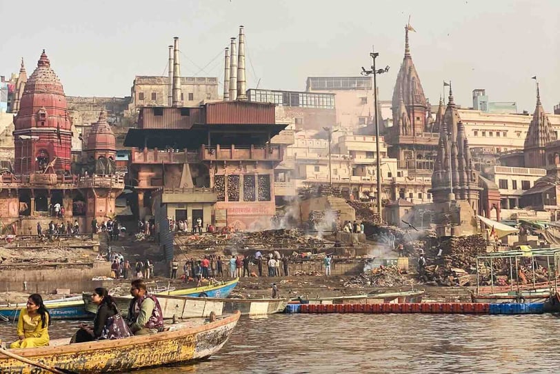 Traditional Hindu cremation ceremony taking place at Manikarnika Ghat in Varanasi, on the banks of the sacred Ganges River.
