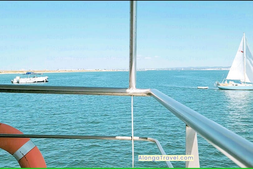 a life-saving ring on a public transport ferry moving from Tavira to the ocean & a view of a yacht 