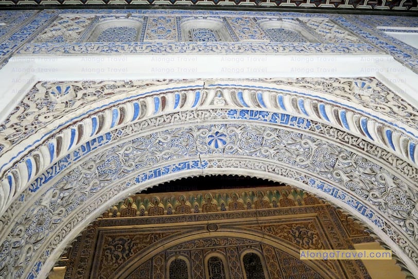 intricate multi-colored dimensional plaster work over a Mudejar style arch