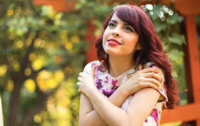 a woman with red hair and a pink dress