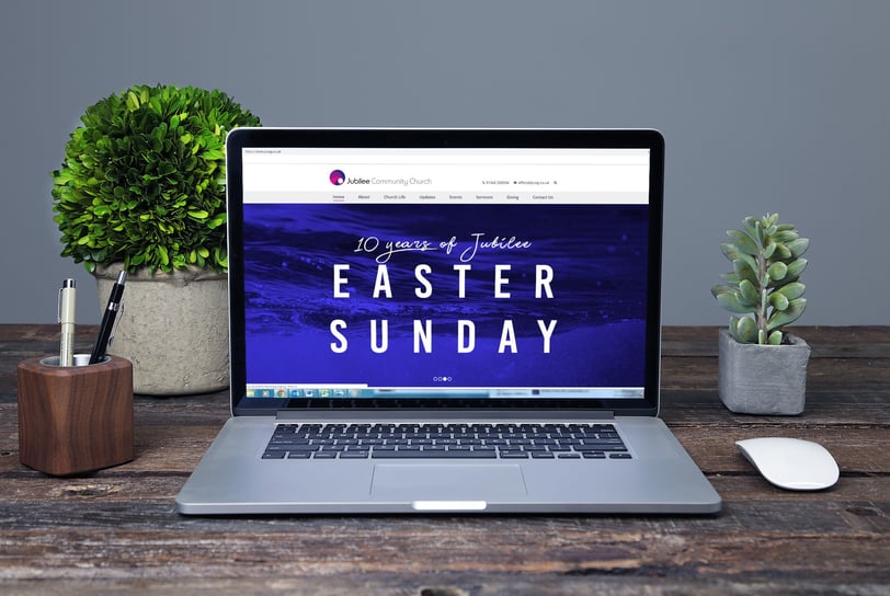 Laptop screen displaying Jubilee Community Church’s website with an Easter Sunday event banner.