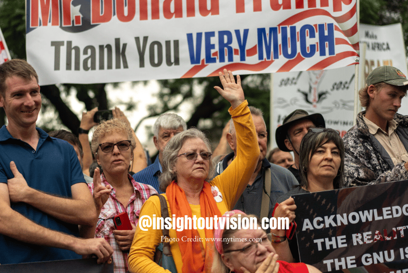 a group of people holding signs and holding signs