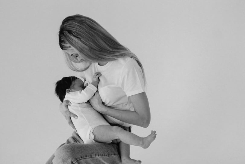 a woman holding a baby in her arms