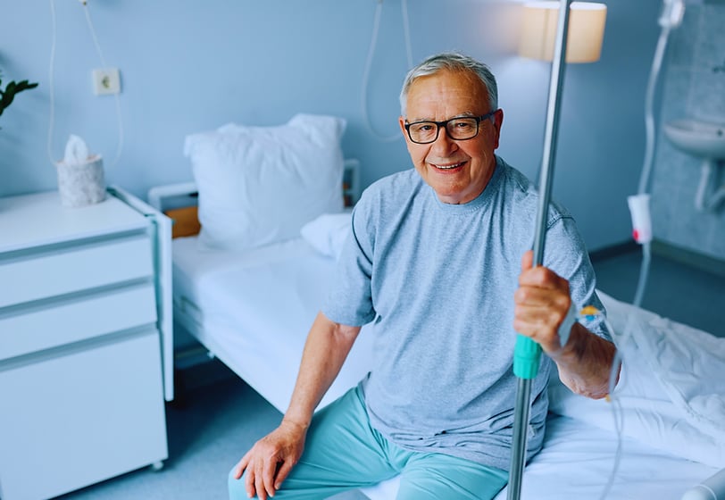 Elderly man receiving IV energy boosting therapy to improve his strength and vitality. Advanced hydr