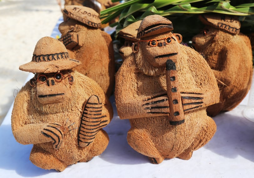 Handcrafted coconut shell monkey souvenirs playing instruments in the Dominican Republic