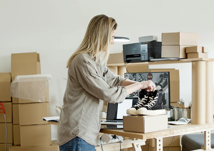 a woman is standing in front of a laptop computer