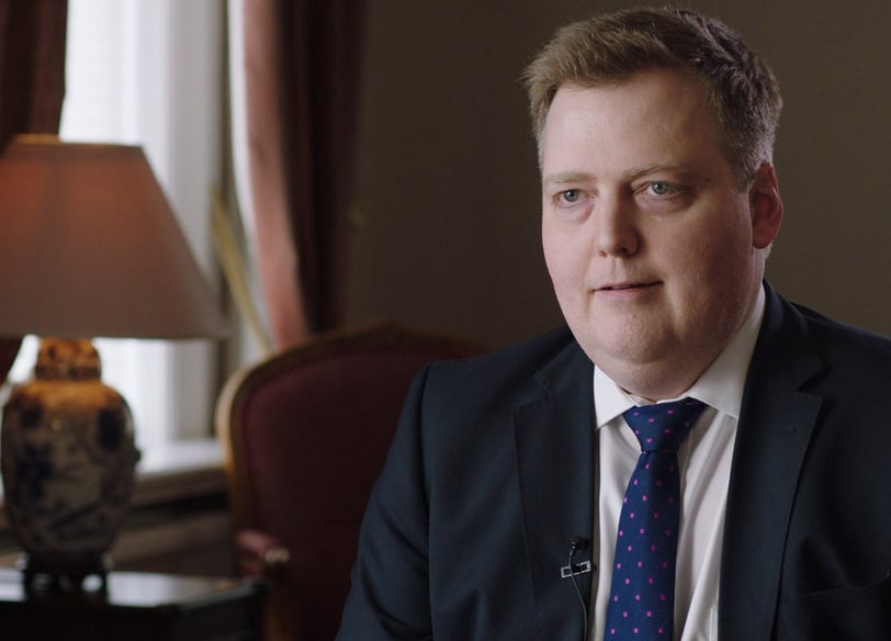 Sigmundur David Gunnlaugsson in a suit and tie sitting in the room