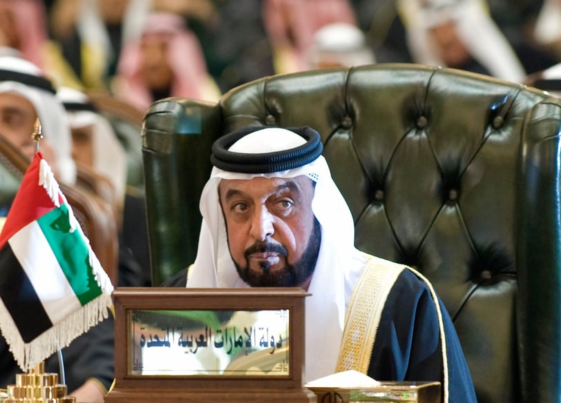 Khalifa bin Zayed Al Nahyan in a suit and sitting on a chair