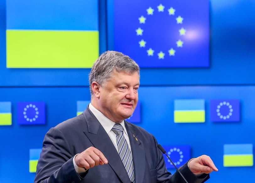 Petro Poroshenko in a suit and tie is giving a speech