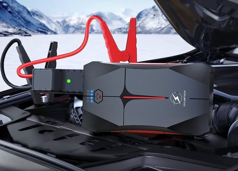 FLYLINKTECH 2500A Jump Starter in action, reviving a car battery with its compact, waterproof and built-in LED flashlight