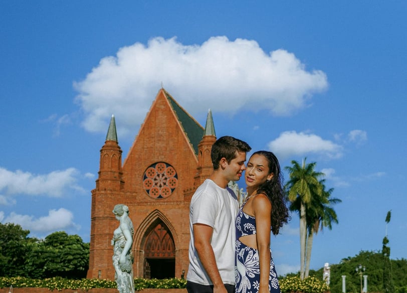 a man and woman standing in front of a church