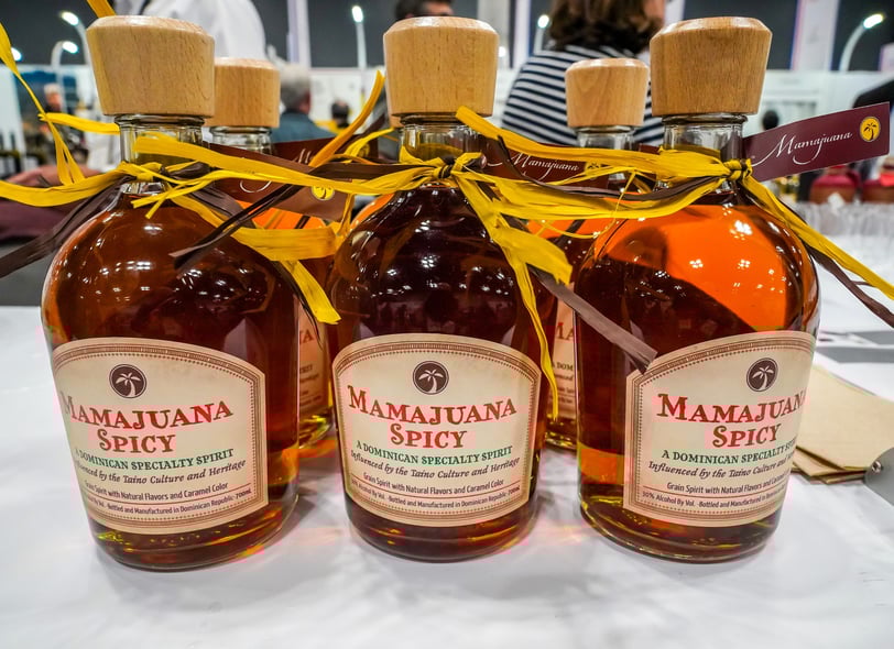 Bottles of Dominican Mamajuana Spicy on display at local market or festival