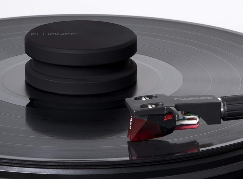 a record player turntable with a black record stabilizer