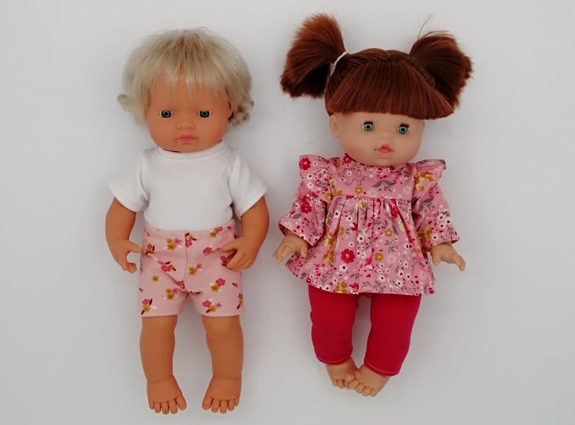 Miniland and Minikane dolls dressed in pink handmade outfits