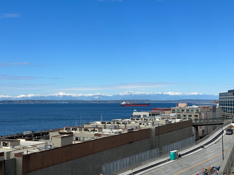 a large ship in the water with mountains in the background