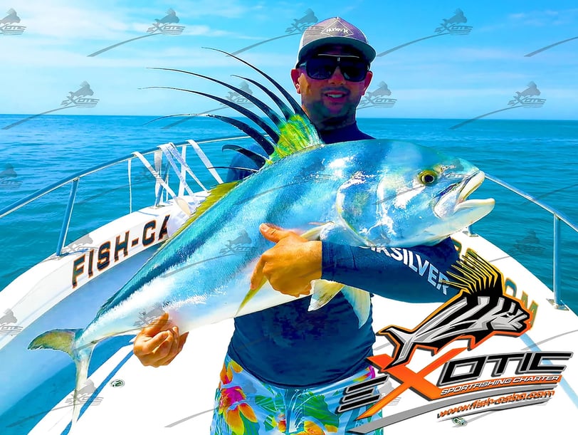 a man holding a fish fish on a boat