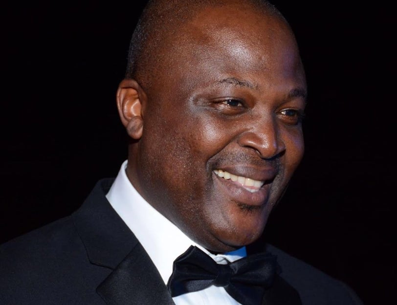 Ibrahim Mahama in a black tuxedo smiling.