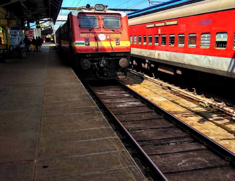 a red train is parked at a train station