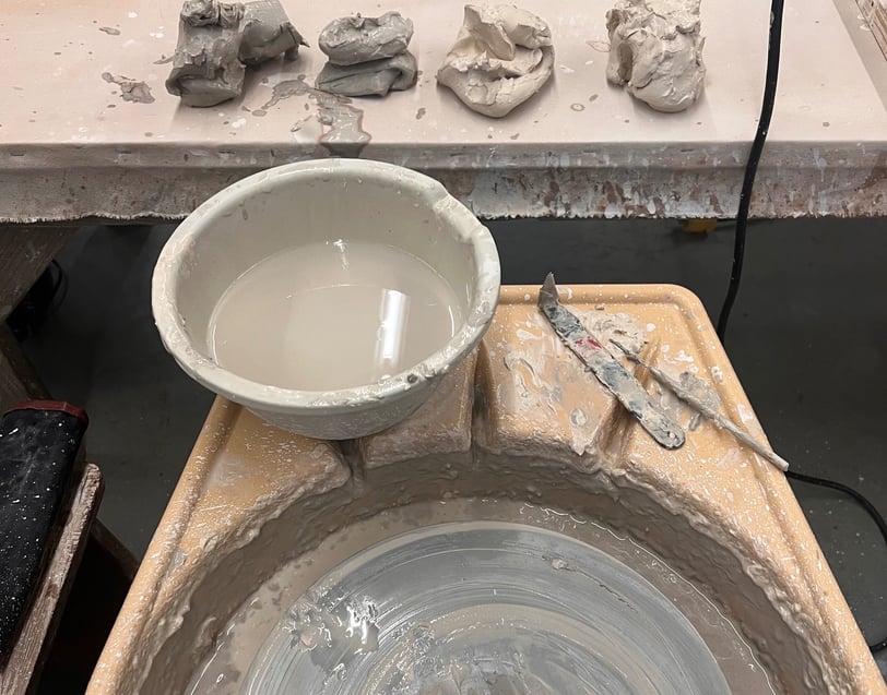 Piles of clay and a potters wheel