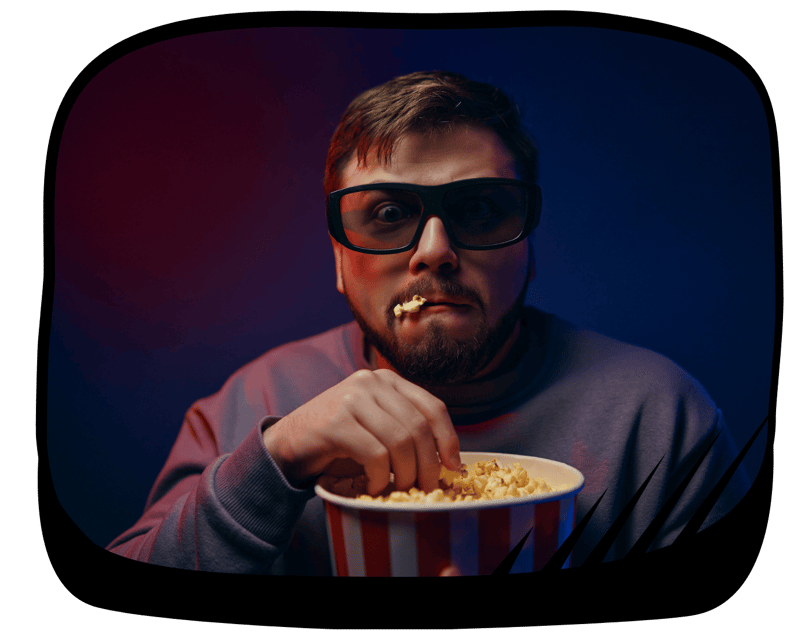 a man with a popcorn in his mouth and a bowl of popcorn