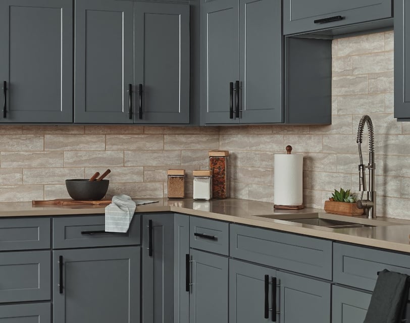 Dark gray shaker style kitchen cabinets with black pull handles