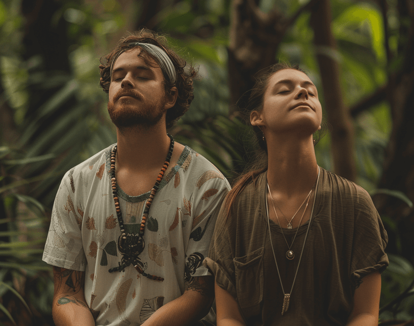 a man and woman sitting on a bench in a forest