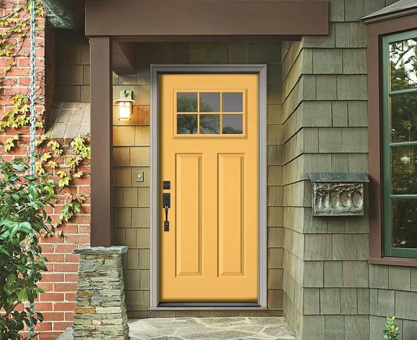 mustard  yellow front door with a green house 