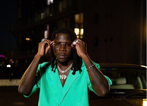 Stonebwoy in a green dress.
