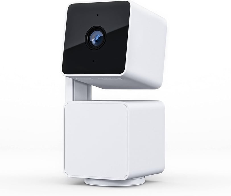 a camera mounted to a white cube with a camera