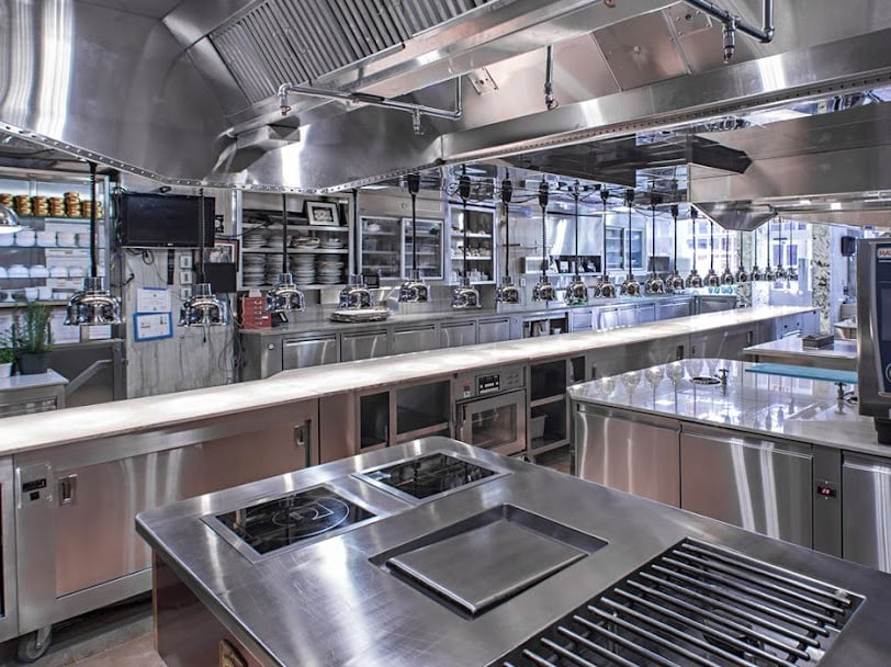 a kitchen with a stove top and a stove top