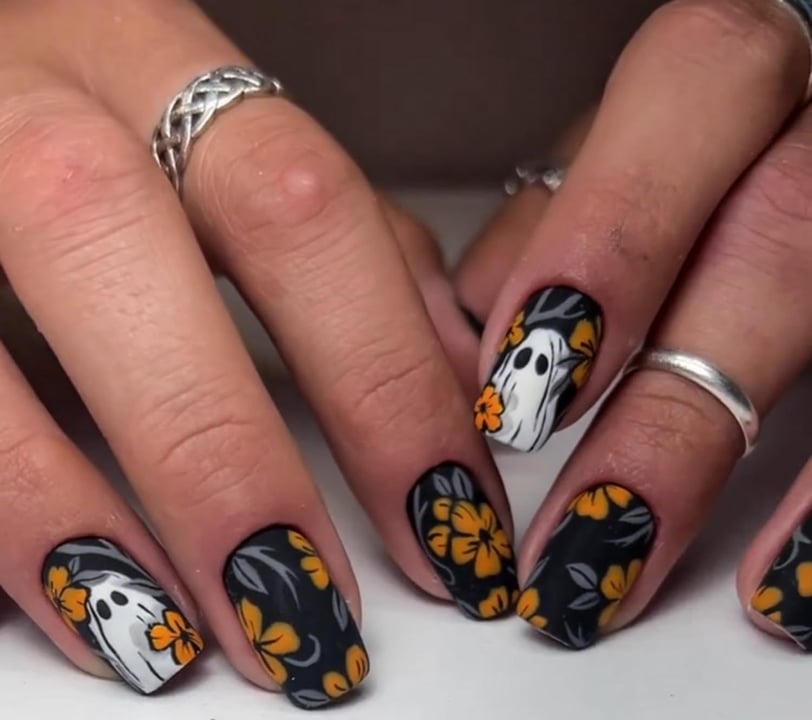 "Spooky Halloween press-on nails featuring vibrant designs and festive colors perfect for adding fla