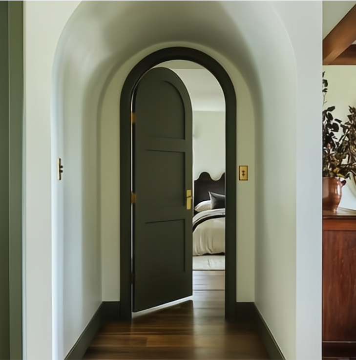 Arched dark green bedroom door with gold hardware