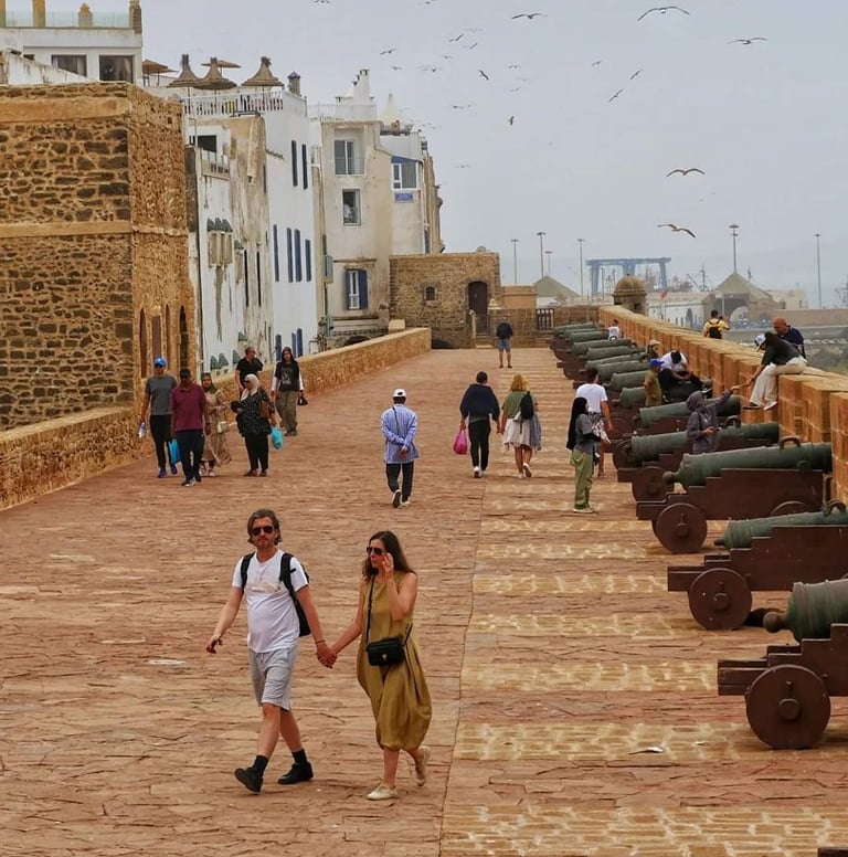 morocco a couple holding hands while walking down a path