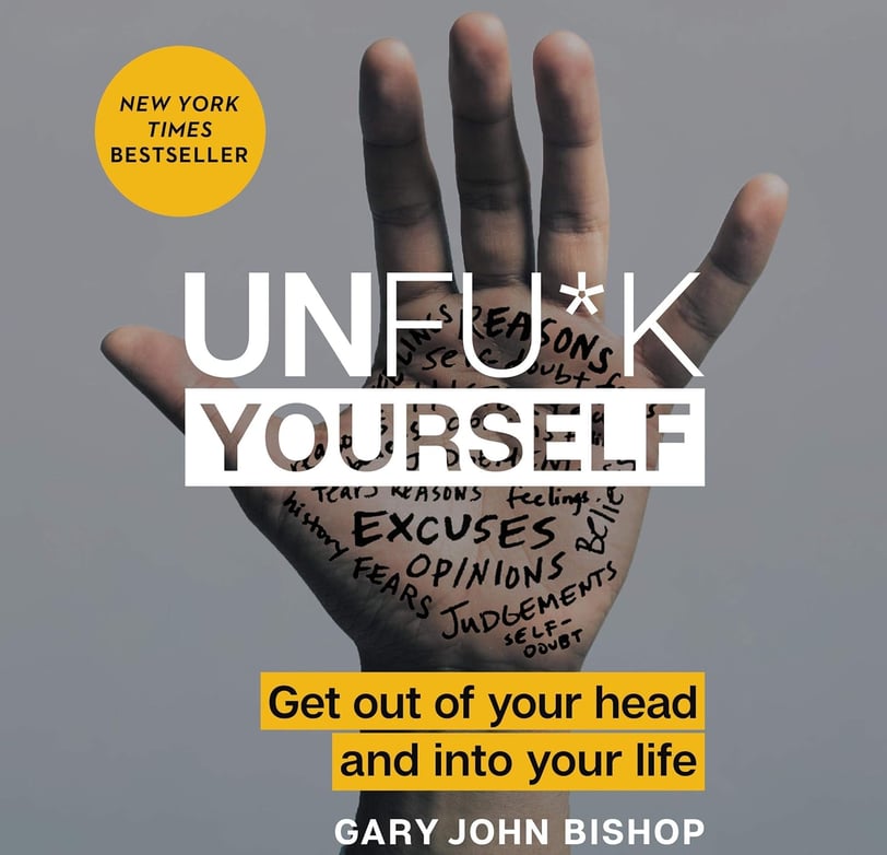a person's hand holding up a hand with the words unfuk yourself