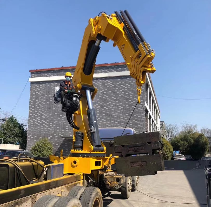 A large object being raised by a crane, specifically a 25 Ton Knuckle Loader Crane.