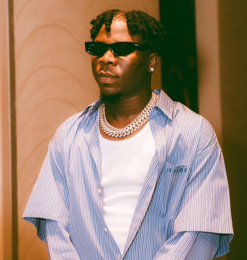 Stonebwoy in a Le Dere shirt with sunglasses.