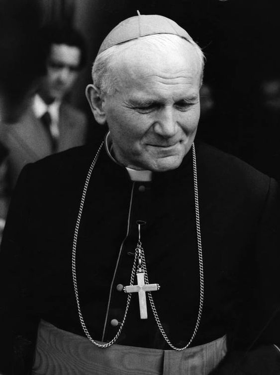 a man in a priest's robes and a cross on a cross - stitch