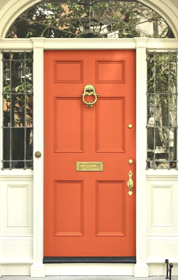 orange front door with gold hardware 