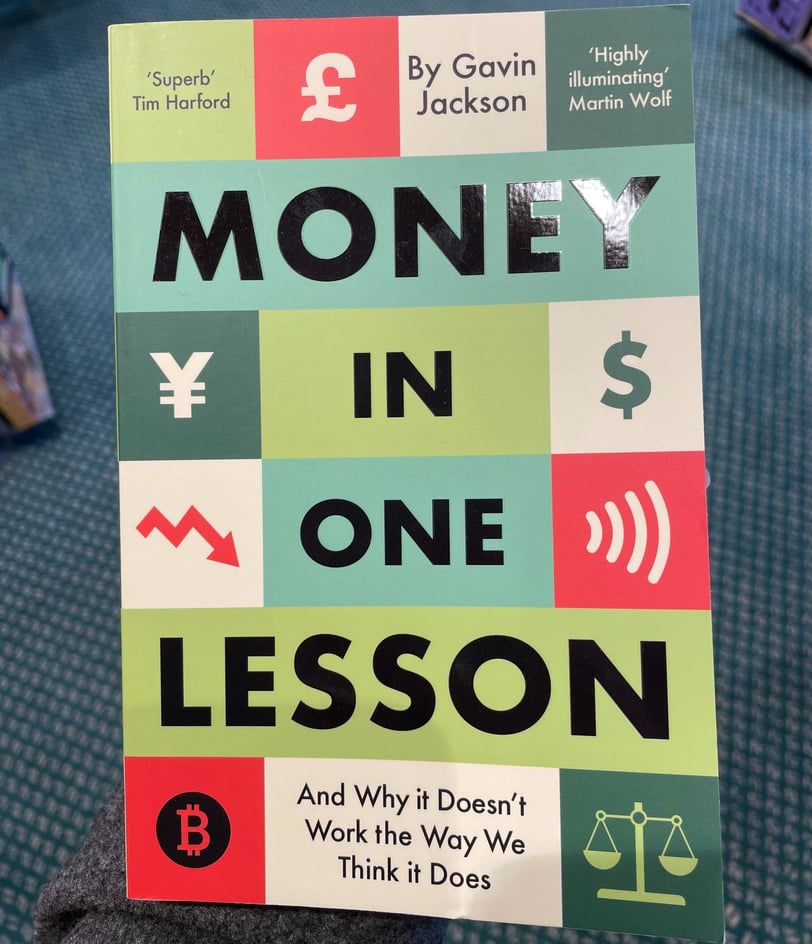 a person holding a book about money