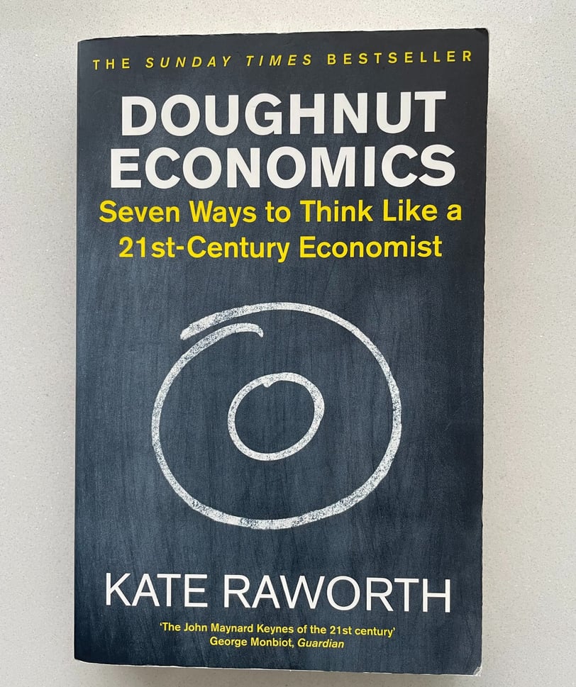 a book cover of Doughnut economics