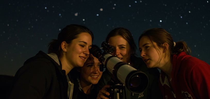 a group of people standing around a telescope