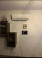 a wall mounted air conditioner with a tv and a television