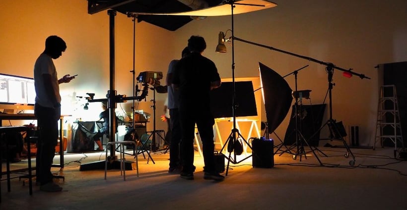 a man standing in front of a camera and a camera