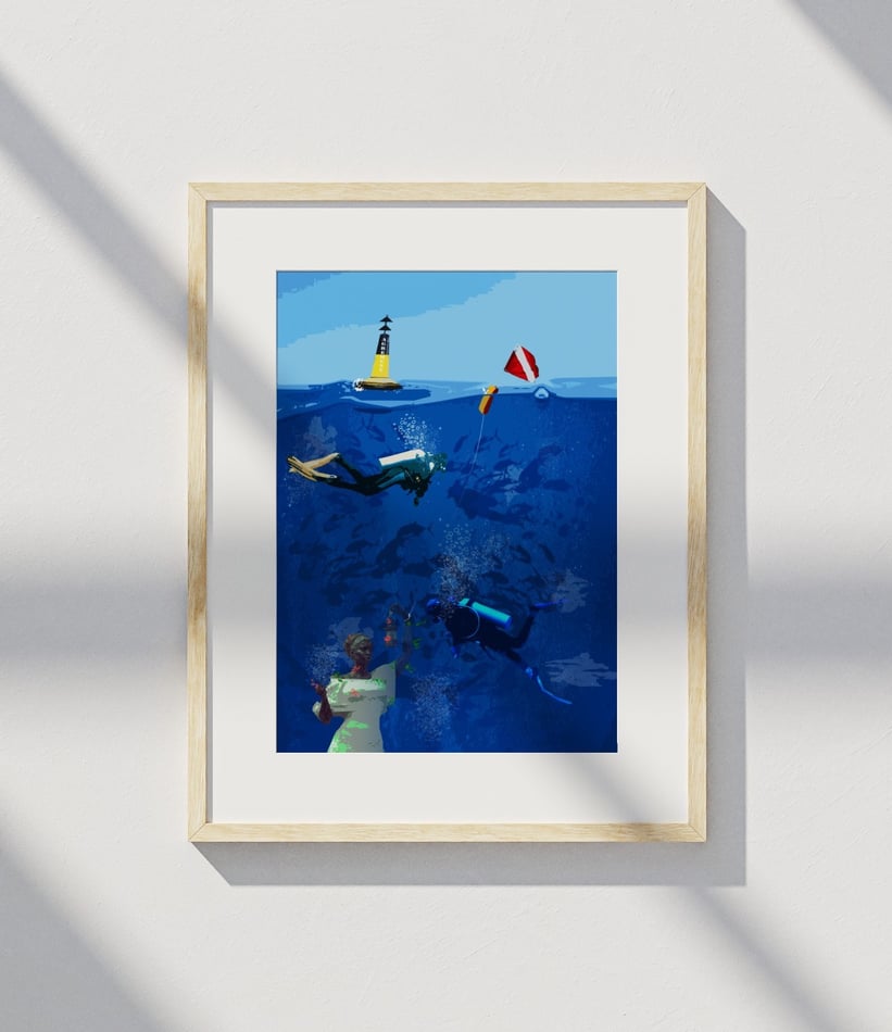 Framed underwater scene with scuba divers and statue