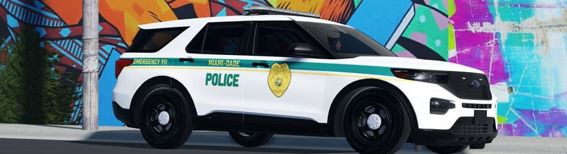 a police car parked in front of a wall with graffiti