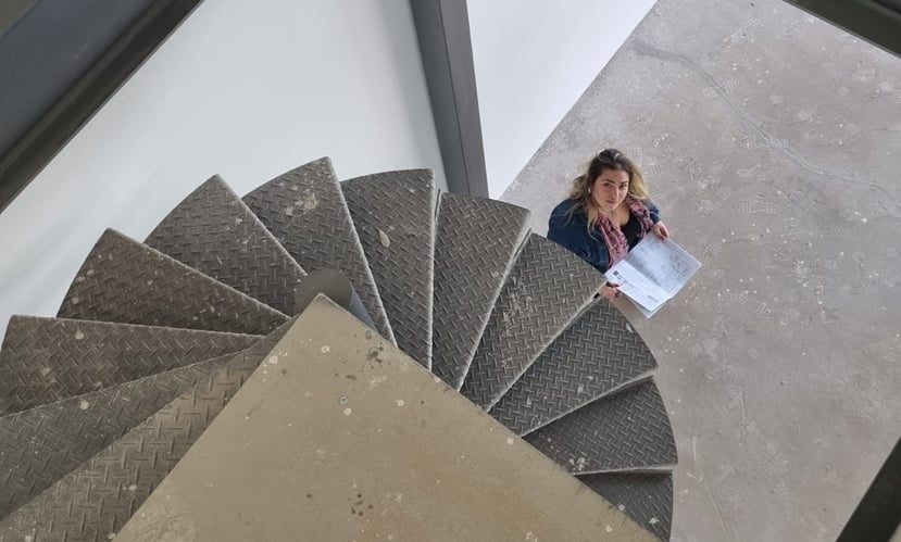 a woman sitting on a spiral staircase case