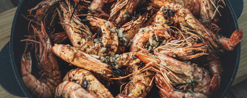 grilled shrimp in a pot with seasoning