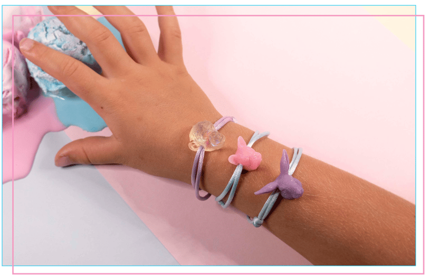 a person's hand holding a bracelet with a butterfly bracelet