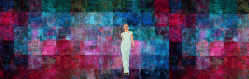 a woman in a white dress standing in front of a colorful background